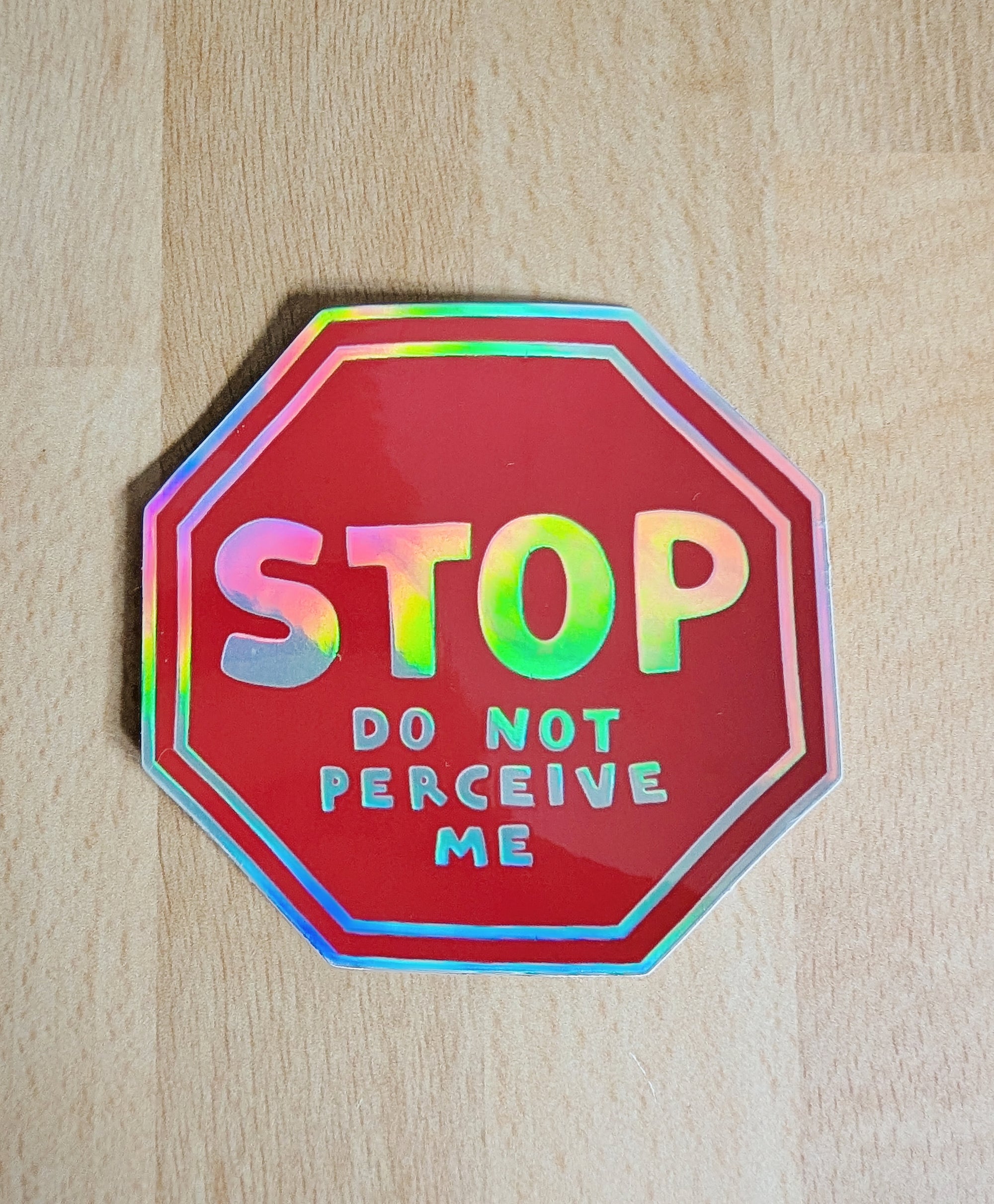 holographic red vinyl sticker with the phrase "STOP do not perceive me"